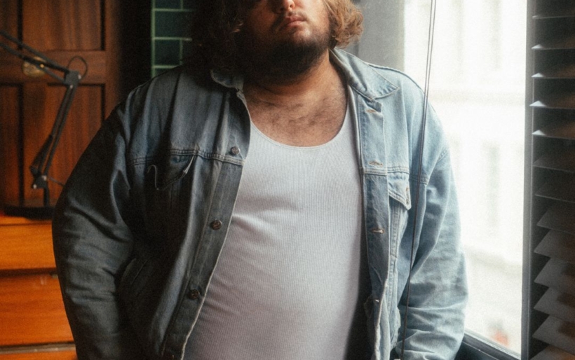 man standing by a window in the daytime